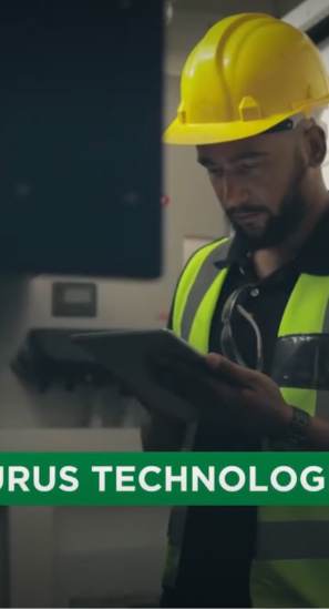 Portrait video still showing a Laurus Technologies technician in a hard hat working with a tablet, Qatar.